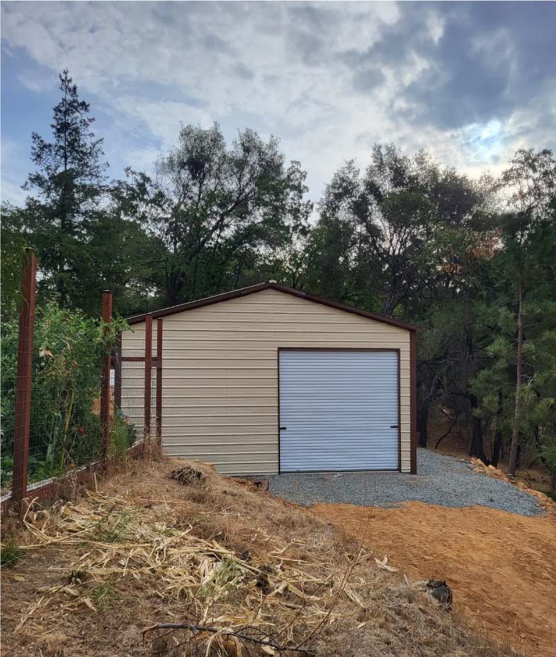 strong metal prefab garages instelled in the woods by quality metal carports, inc