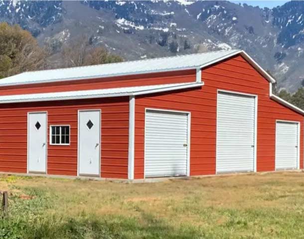 red and white pole barn in the mountains